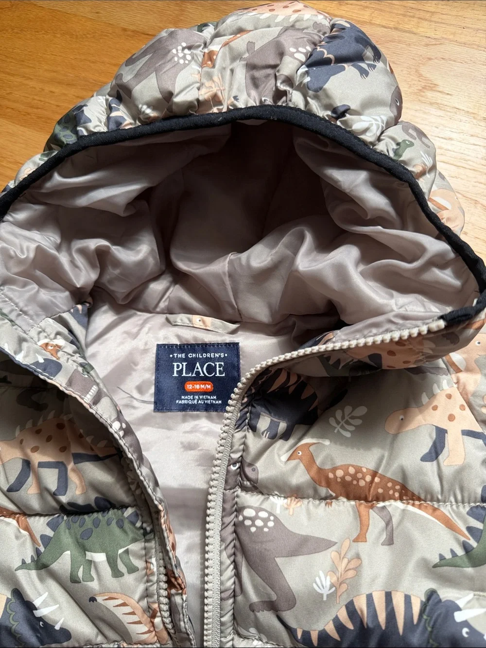 The Children's Place Dino Hooded Puffer Jacket in Tan, Green & Navy
